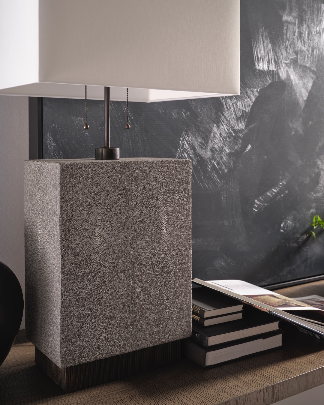 Carefully wrapped in genuine shagreen with textured brass accents, the Scoria Table Lamp is evocative of the dark volcanic rock that displays a uniquely bubbled texture. Its pull-chain design is inspired by the chimera, a firebreathing creature from Greek mythology that represents untamed power. Visit the link in our bio for more information. #ThingsChosenWell #SusanFerrier