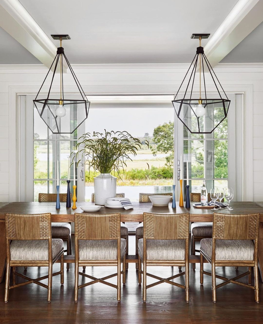 Beautiful coastal dining room by @audreysterkdesign featuring our Alameda Dining Side Chair from the McGuire Originals Collection. A study in rawhide weaving, interlocking rawhide straps are wrapped to make an intricate and comfortable pattern on the back. Rawhide gains strength and durability over time; these are pieces that will last for generations. Custom rawhide program available. Photography by @readmckendree and architecture by Botticelli and Pohl. Visit the link in our bio for more information. #ThisIsMcGuire